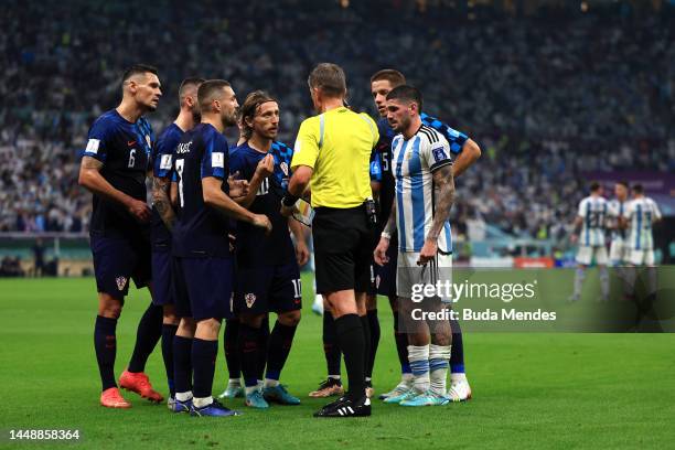 Croatia players protest to Referee Daniele Orsato after the penalty decision during the FIFA World Cup Qatar 2022 semi final match between Argentina...