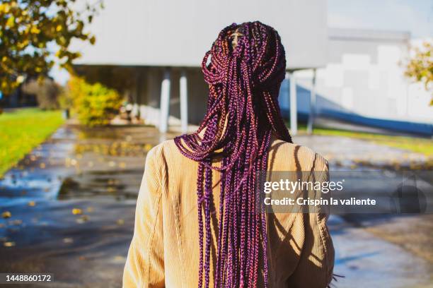 back view of woman with purple sewn braids by the street - cornrows stock pictures, royalty-free photos & images