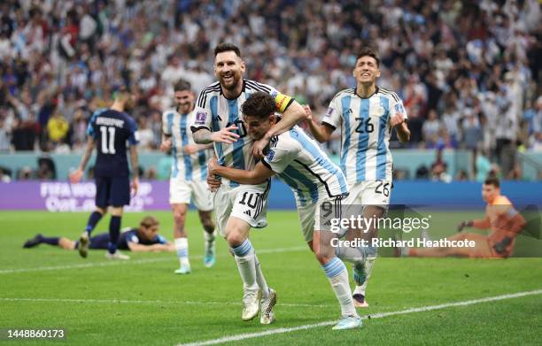 Julian Alvarez celebrates with Lionel Messi of Argentina after scoring the team's second goal during the FIFA World Cup Qatar 2022 semi final match...