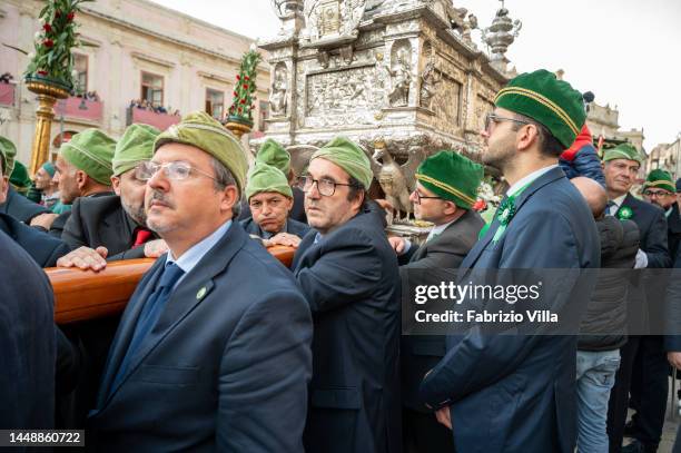 Detail of some of the bearers of Saint Lucy, the men carrying the statue of the Saint on their shoulders during the procession on December 13, 2022...
