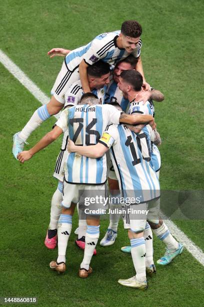 Lionel Messi of Argentina celebrates with team mates after scoring their sides first goal from the penalty spot during the FIFA World Cup Qatar 2022...