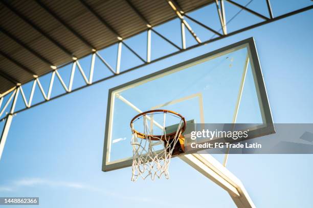 basketball hoop at the sports court - basketball court stock pictures, royalty-free photos & images