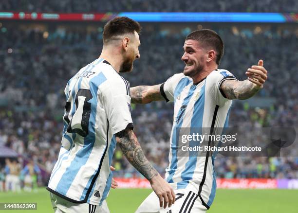 Lionel Messi of Argentina celebrates with teammate Rodrigo De Paul after scoring their sides first goal from the penalty spot during the FIFA World...