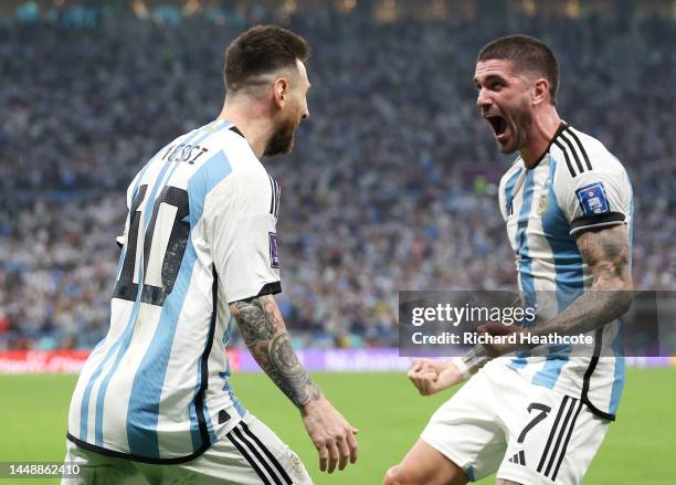 Lionel Messi of Argentina celebrates with teammate Rodrigo De Paul after scoring their sides first goal from the penalty spot during the FIFA World...