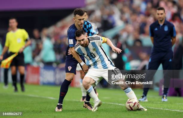 Lionel Messi of Argentina controls the ball against Ivan Perisic of Croatia during the FIFA World Cup Qatar 2022 semi final match between Argentina...