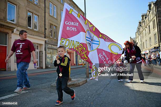 Fans gather to see Hearts players parade along Gorgie Road on an open top bus, following their Scottish Cup final win over rivals Hibernian on May...