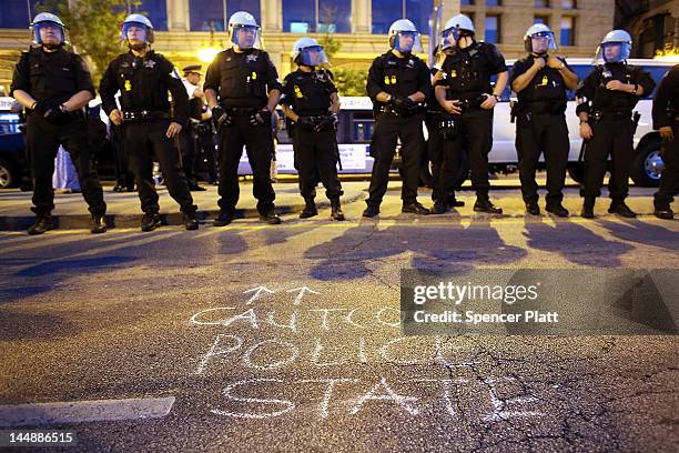 Chicago police officers watch protesters during a demonstration by Occupy Wall Street and other groups in downtown Chicago on the eve of the NATO...