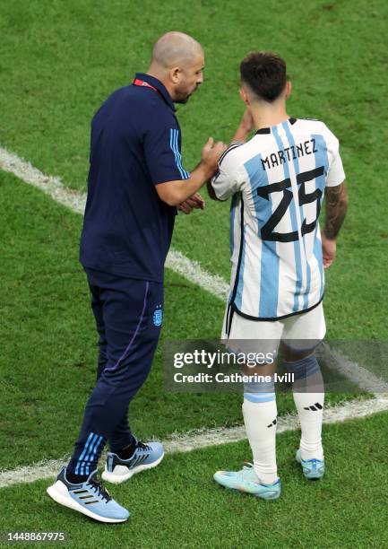 Lisandro Martinez of Argentina interacts with assistant coach Walter Samuel during the FIFA World Cup Qatar 2022 semi final match between Argentina...