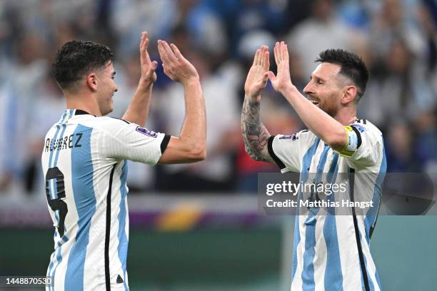 Julian Alvarez celebrates with Lionel Messi of Argentina after scoring the team's third goal during the FIFA World Cup Qatar 2022 semi final match...