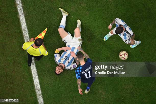 Lionel Messi of Argentina reacts after a challenge as Marcelo Brozovic of Croatia approaches during the FIFA World Cup Qatar 2022 semi final match...