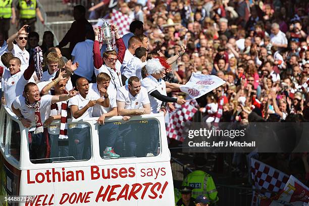 Hearts players parade along Gorgie Road on an open top bus following following their Scottish Cup final win over rivals Hibernian on May 20, 2012 in...