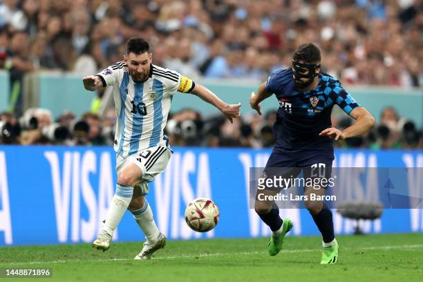 Lionel Messi of Argentina battles for possession with Josko Gvardiol of Croatia during the FIFA World Cup Qatar 2022 semi final match between...
