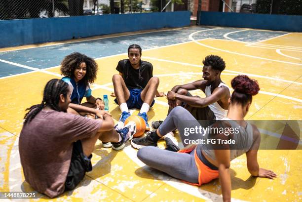 friends talking in a sports court - amateur photography stock pictures, royalty-free photos & images
