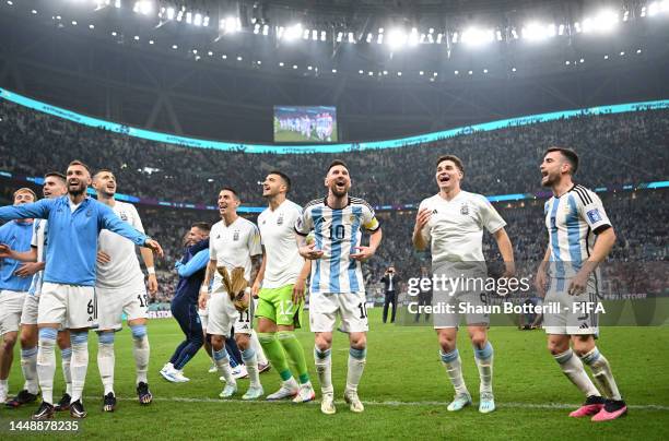 Lionel Messi, Julian Alvarez and Nicolas Tagliafico of Argentina celebrate with the fans after the team's victory during the FIFA World Cup Qatar...