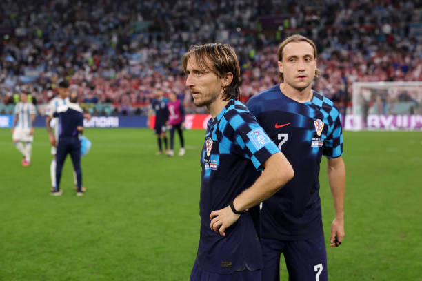 Luka Modric and Lovro Majer of Croatia show dejection after the 0-3 loss during the FIFA World Cup Qatar 2022 semi final match between Argentina and...