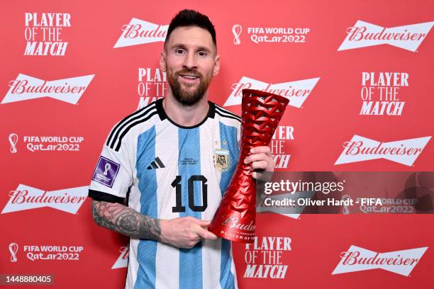 Lionel Messi of Argentina poses with the Budweiser Player of the Match Trophy following the FIFA World Cup Qatar 2022 semi final match between...