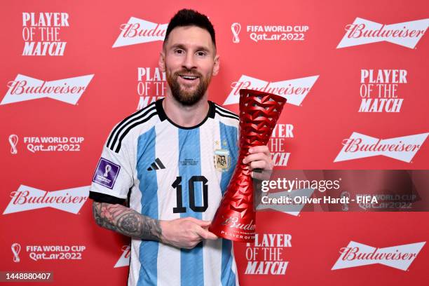 Lionel Messi of Argentina poses with the Budweiser Player of the Match Trophy following the FIFA World Cup Qatar 2022 semi final match between...