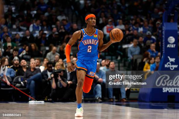 Shai Gilgeous-Alexander of the Oklahoma City Thunder dribbles the ball up the court against the Dallas Mavericks in the first half of the game at...