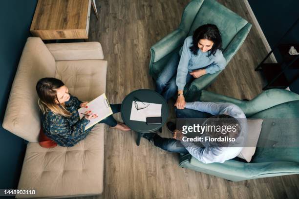 three persons talking in the office - people family group sad stock pictures, royalty-free photos & images