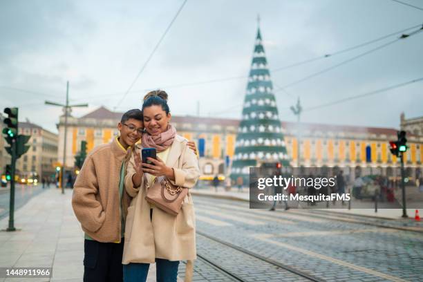 people using smartphone at christmas in lisbon - portuguese culture stock pictures, royalty-free photos & images