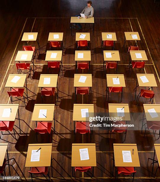 teacher sits in exam hall - examination room stock pictures, royalty-free photos & images