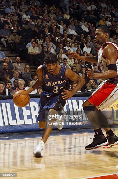 Richard Hamilton of the Washington Wizards drives past Cuttino Mobley of the Houston Rockets on his way to the basket in a game at the Compaq Center...