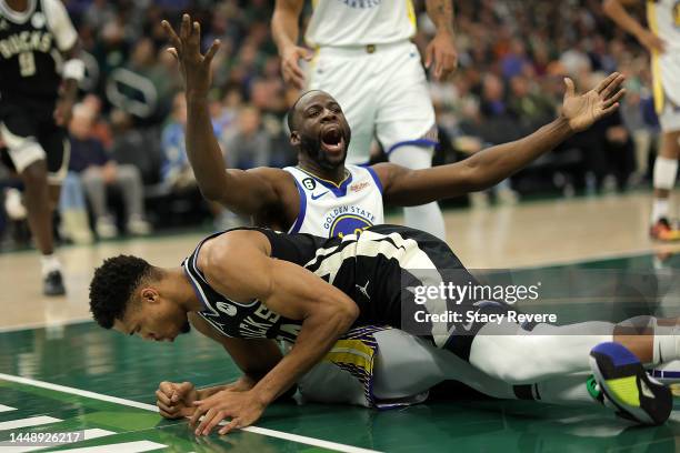 Giannis Antetokounmpo of the Milwaukee Bucks is fouled by Draymond Green of the Golden State Warriors during the first half of a game at Fiserv Forum...