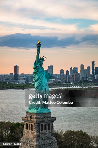 Aerial of the Statue of Liberty at sunset, New York city, USA
