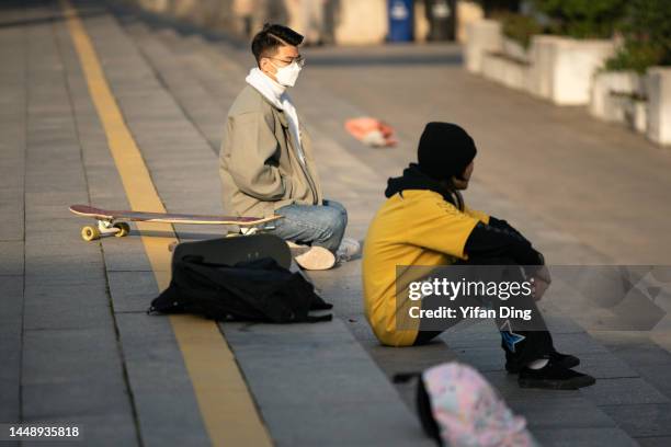 Skateboarders rest in an outdoor park on December 13, 2022 in Shanghai, China. The central government recently eased coronavirus restrictions. Health...