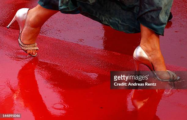 The red carpet is soaked through with rain as guests attend the "Amour" Premiere during the 65th Annual Cannes Film Festival at Palais des Festivals...