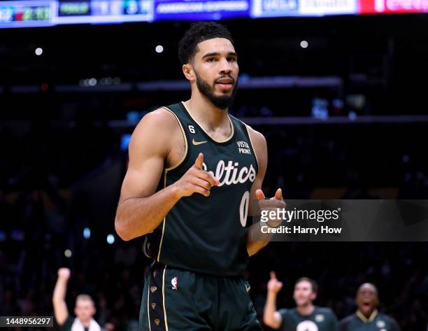 Jayson Tatum of the Boston Celtics celebrates his basket with a Los Angeles Lakers foul during the first half at Crypto.com Arena on December 13,...