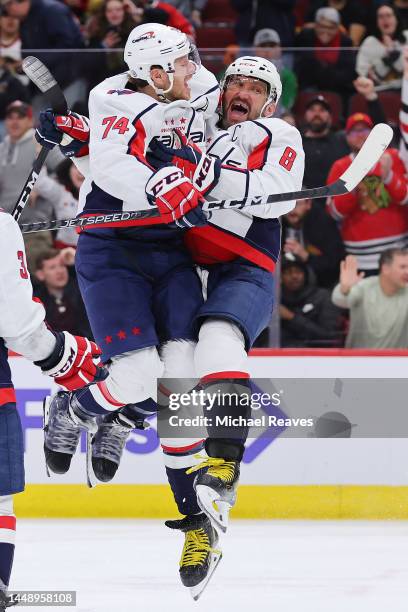 Alex Ovechkin of the Washington Capitals celebrates with John Carlson after scoring his 800th career goal during the third period against the Chicago...