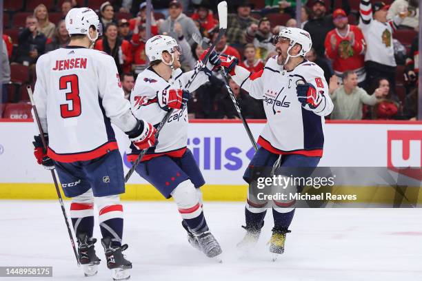 Alex Ovechkin of the Washington Capitals celebrates with John Carlson and Nick Jensen after scoring his 800th career goal during the third period...