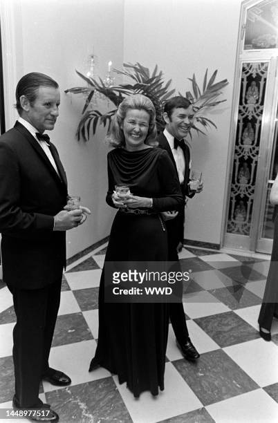 Louise Shepard laughs with guests at a dinner dance hosted by Lynn Wyatt.
