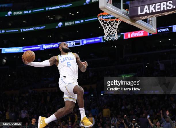 LeBron James of the Los Angeles Lakers dunks during a 122-118 loss to the Boston Celtics at Crypto.com Arena on December 13, 2022 in Los Angeles,...