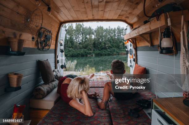 couple enjoying the view from their van - magenta car stock pictures, royalty-free photos & images