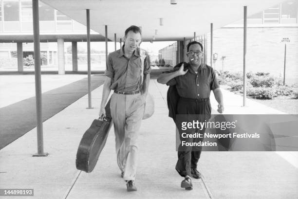 Folk musician and activist Pete Seeger and writer and poet Langston Hughes backstage at the Newport Folk Festival in July 1959 in Newport, Rhode...
