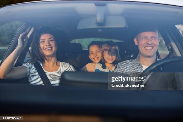 young happy family enjoying while traveling by car. - happy family in car stock pictures, royalty-free photos & images