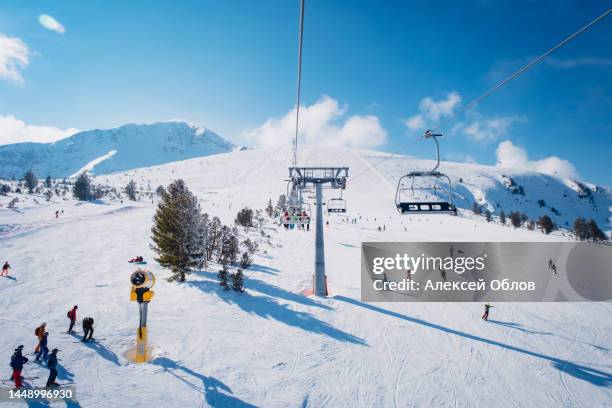 chair lift in the ski resort of bansko, bulgaria. winter landscape in the pirin mountains - bansko stock pictures, royalty-free photos & images