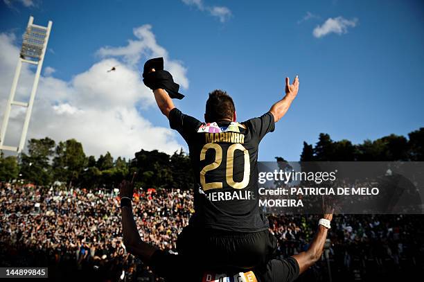 Academica's forward Mario Tomas "Marinho" celebrates his team's victory over Sporting Lisbon at the end of their Portuguese Cup final football match...