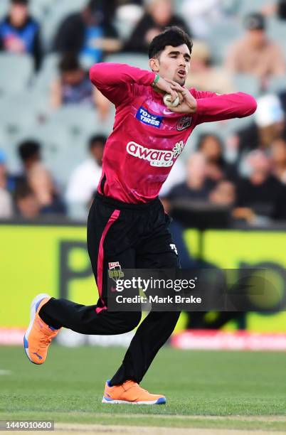 Izharulgaq Naveed of the Sixers bowlsduring the Men's Big Bash League match between the Adelaide Strikers and the Sydney Sixers at Adelaide Oval, on...