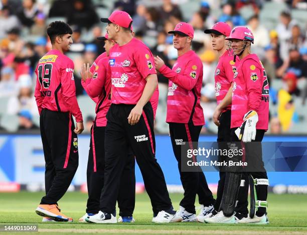 Izharulgaq Naveed of the Sixers celebrates the wicket of Chris Lynn of the Strikers during the Men's Big Bash League match between the Adelaide...