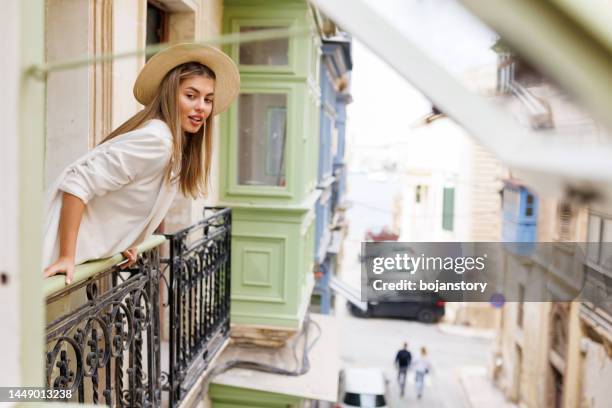 admiring city architecture from terrace - maltese adult stock pictures, royalty-free photos & images