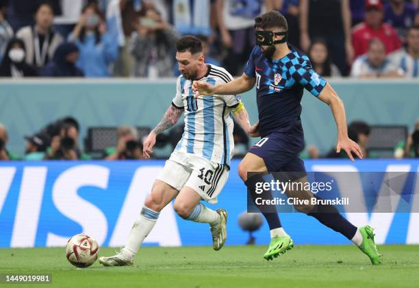 Lionel Messi of Argentina in action with Josko Gvardiol of Croatia during the FIFA World Cup Qatar 2022 semi final match between Argentina and...