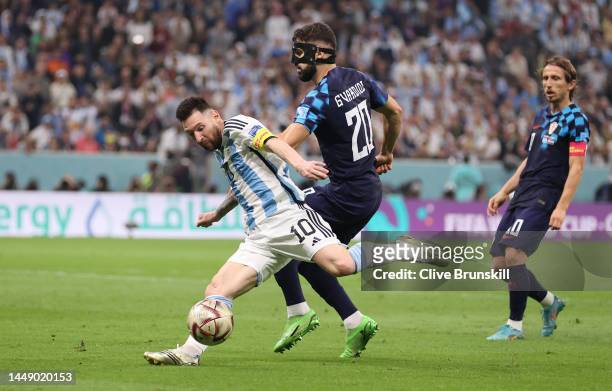 Lionel Messi of Argentina attempts a shot at goal whilst under pressure from Josko Gvardiol of Croatia during the FIFA World Cup Qatar 2022 semi...