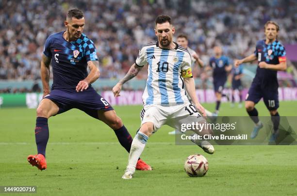 Lionel Messi of Argentina in action with Dejan Lovren of Croatia during the FIFA World Cup Qatar 2022 semi final match between Argentina and Croatia...