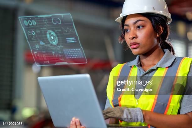 confident engineer use the laptop and compare data with digitization display in a heavy industrial factory, concepts engineer working in the factory. - data driven stock-fotos und bilder