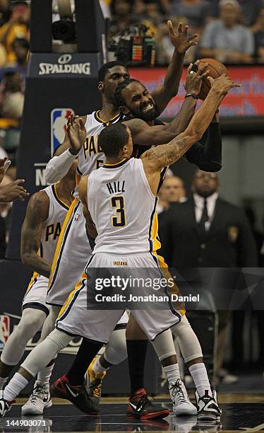 George Hill and Roy Hibbert of the Indiana Pacers pressure Ronny Turiaf of the Miami Heat in Game Four of the Eastern Conference Semifinals in the...