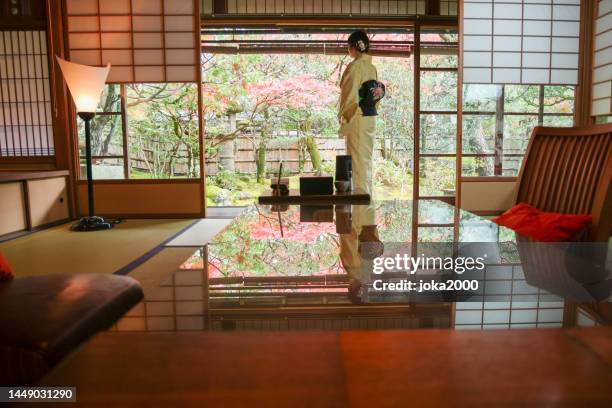 japanese lady relaxing in room of traditional japanese hostel - heritage hall stock pictures, royalty-free photos & images