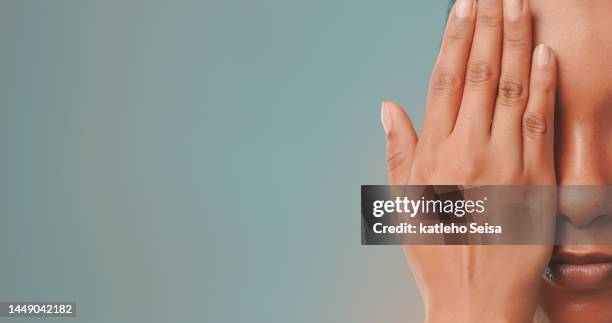 studio shot of woman covering her face with hand - 21 & over stock pictures, royalty-free photos & images